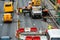 Employees of the road service in special yellow vests perform work on the repair of the roadway. Restoration of the deformation