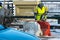 Employees of the road service in special yellow vests perform work on the repair of the roadway. Restoration of the deformation