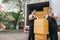 Employees work together unloading cardboard boxes from the truck for a customer