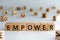 empower - word from wooden blocks with letters