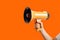 Empowering Marketing and Sales Illustration of Hand Holding Megaphone on Vibrant Orange Background. created with Generative AI