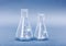 Empty 50 and 100 milliliter Erlenmeyer chemistry flasks