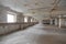 Empty abandoned technical floor on the roof or semi-basement of the house with row of windows and white walls