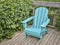 Empty Adirondack chair on a wooden backyard dec