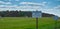 Empty airfield for gliders on a grassy area with a sign with German inscription: airfield, no trespassing