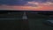 Empty airport runaway with braking and maneuvering marks, designation 29 and all navigation lights on clear for airplane landing