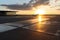 empty airport terminal, with view of the tarmac and runways, during sunset