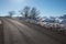 Empty alpine mountain road in winter, blue sky