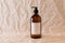 Empty amber glass soap or shampoo bottle on isolated background. Skin care or hair concept with natural cosmetics