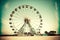 empty amusement park and large round ferris wheel