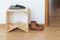 Empty anteroom with wooden stool and leather boots