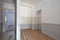 Empty apartment interior with kitchen area, corridor with room