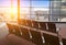 Empty armchairs in hall of expectation of airport and plane behind window