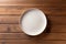 empty artistic ceramic Glazed earthenware white fancy shape plate, golden cutlery on side.