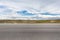 Empty asphalt pavement with plateau wetland