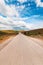 Empty asphalt road through beautiful Zlatibor region landscape stretching in diminishing perspective and disappearing behind the