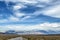 Empty asphalt road with cloudy sky and sunlight