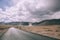 empty asphalt road in mountain valley and cloudy sky in Indian Himalayas,