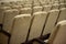 Empty auditorium with beige chairs, theatre or conference hall