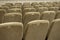 Empty auditorium with beige chairs, theatre or conference hall