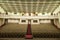 Empty auditorium with beige chairs, theatre or conference hall.