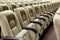 Empty auditorium with beige chairs, theatre or conference hall.