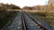 Empty autumn railway and forest