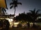 Empty backyard of hotel in Philippines islands. Tropical resort in sunset light. Wooden path in tropical patio. Exotic vacation.