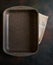 Empty baking tray with non-stick granite coating on dark background