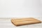 Empty bamboo cutting board on a white wooden