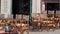 Empty bar or restaurant in europe with wooden tables without people. Small business losses and consequences of the