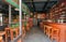 Empty bar with wooden tables, bottles, drinks and colorful decoration