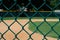 Empty Baseball Field through Fence