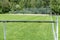 Empty baseball or softball diamond from the back fence and foul line looking towards the grass and trees in Whistler, British