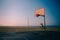 Empty basketball court near the beach, during a quiet sunset