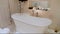 Empty Bathtub with Bubbles and Foam in Luxury Bathroom with Candles