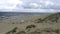 An empty beach, bathed in the muted light of a cloudy day