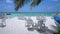 Empty beach cafe with chairs and tables near tropical sea