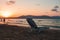 Empty beach chair on a sandy beach on a sunset background