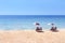 Empty beach chairs on sand beach with blue sky and sea, no tourists on beach, empty summer in Thailand