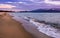 Empty beach in the evening - waves crashing on the sand