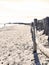 Empty beach with one single Person walking or jogging along the water