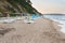 Empty beach on the seaside at the end of day with empty sun loungers and umbrellas in the evening