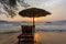 Empty beach with straw umbrella on sunrise in Koh Rong, Cambodia