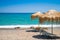 Empty beach with straw umbrellas and sunbeds, Crete, Greece