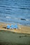 Empty beach with three sun loungers on sand