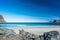 Empty beautiful beach during springtime on a sunny day with blue sky and silent ocean with small waves.