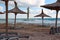 Empty beautiful beach at Vama Veche, Romania, with wicker umbrellas