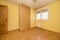 Empty bedroom with built-in wardrobe with oak doors to match