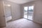 Empty bedroom with large sliding glass door to the deck of the backyard in southern California home